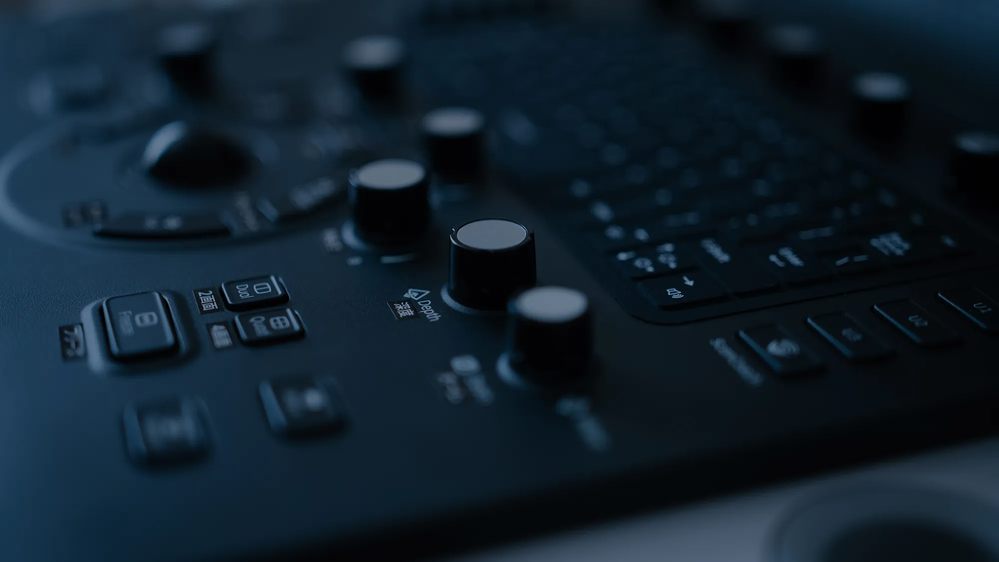 Close-up of a professional audio mixing console with knobs and buttons